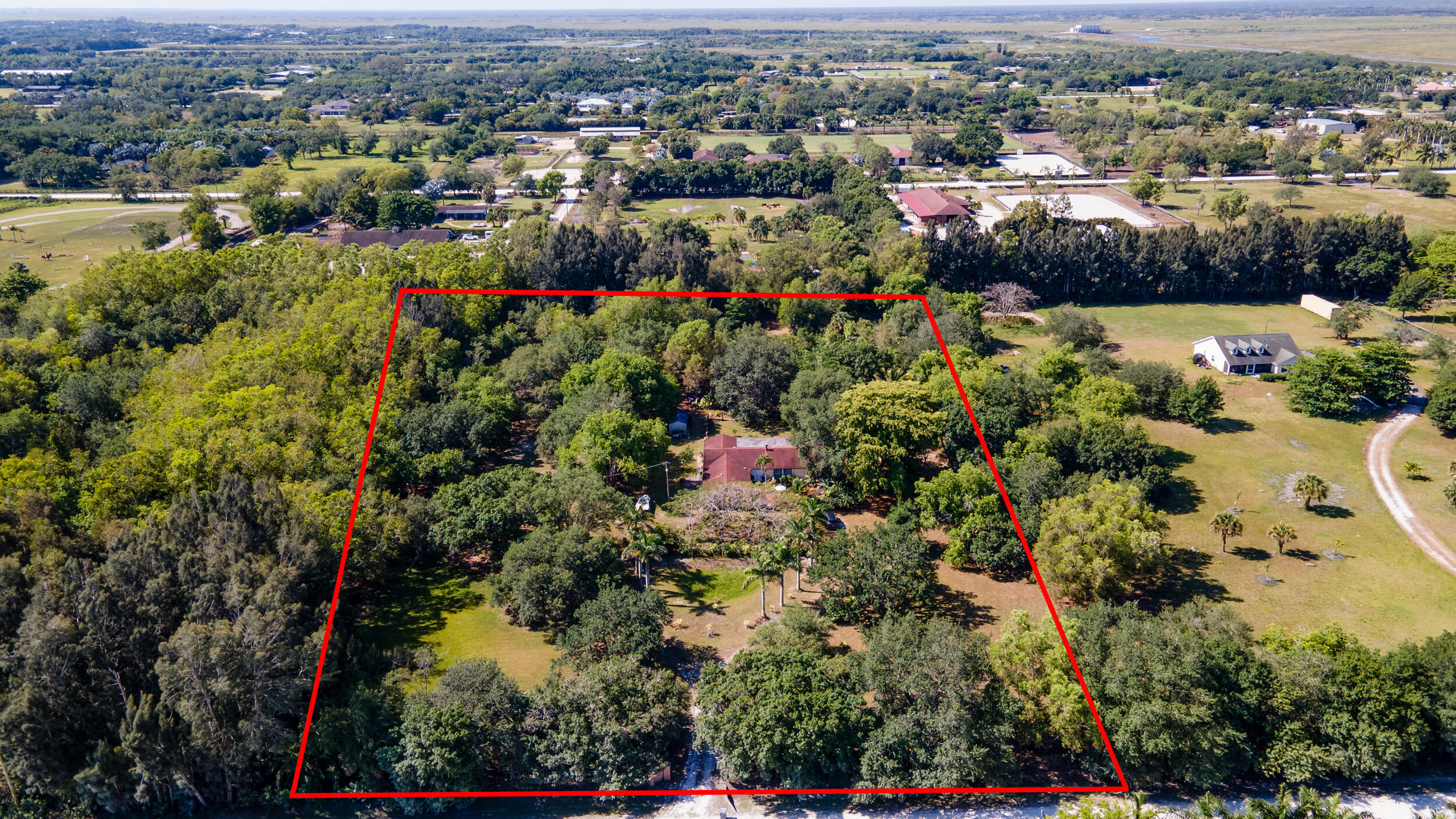 16688 Rustic Road Wellington, FL 33470 - Photo 4 of 14 an aerial view of a houses with a lake and green space