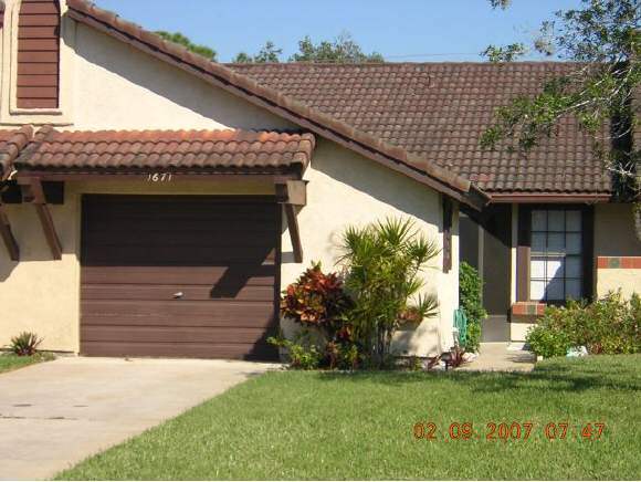 1671 Northeast Avery Palm Bay, FL 32905 - Photo 1 of 8 a front view of a house with a yard