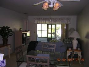 1671 Northeast Avery Palm Bay, FL 32905 - Photo 6 of 8 a living room with furniture and a chandelier