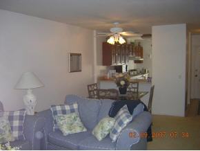 1671 Northeast Avery Palm Bay, FL 32905 - Photo 7 of 8 a living room with furniture and a chandelier