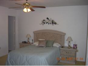1671 Northeast Avery Palm Bay, FL 32905 - Photo 8 of 8 a bedroom with a bed and chandelier