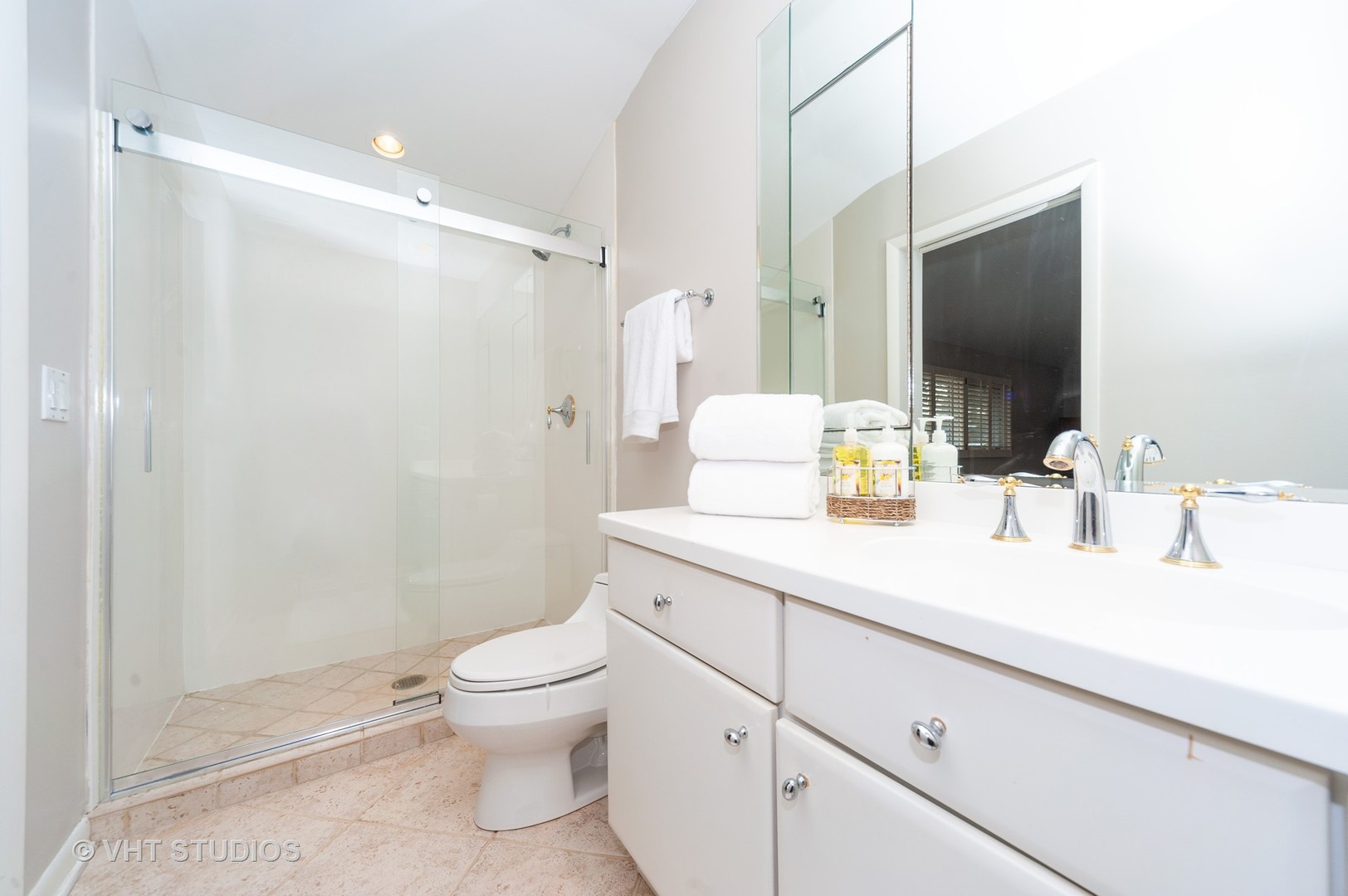 1555 Tower Road Winnetka, IL 60093 - Photo 19 of 27 a bathroom with a sink a toilet and a large mirror