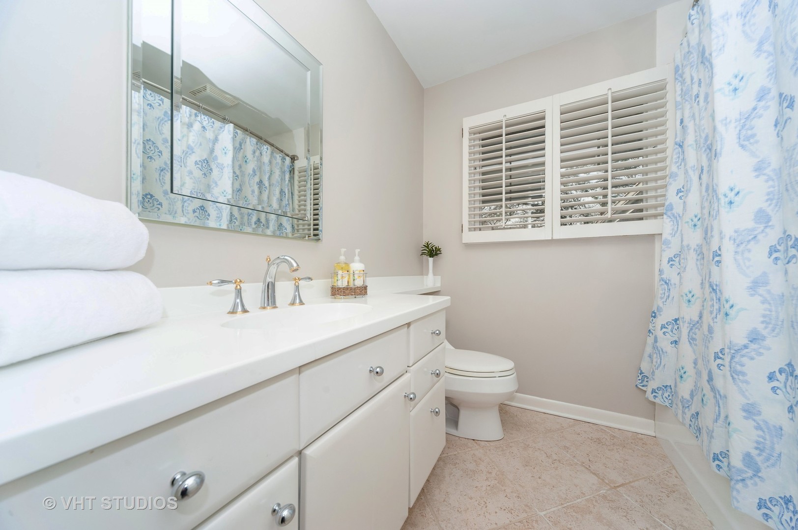 1555 Tower Road Winnetka, IL 60093 - Photo 20 of 27 a bathroom with a sink a toilet and a window