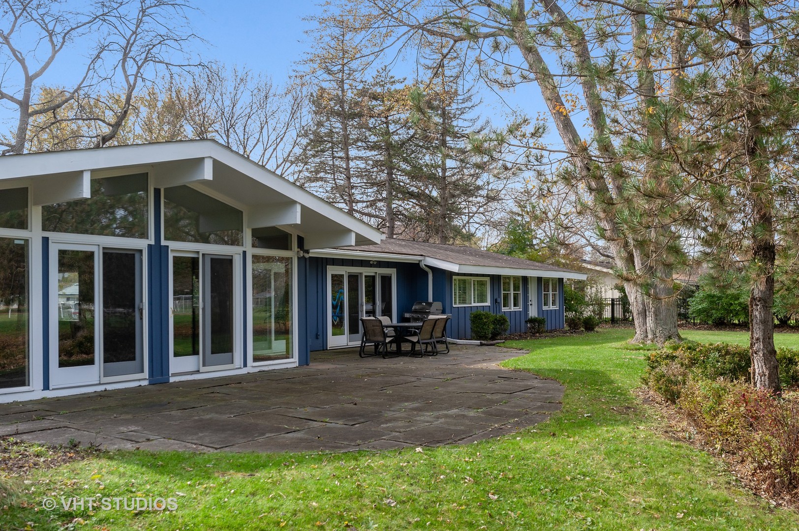 1555 Tower Road Winnetka, IL 60093 - Photo 23 of 27 a front view of a house with a yard and trees