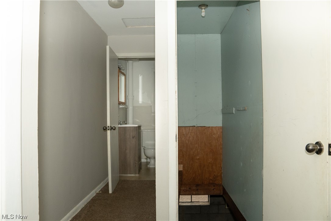 32 Lee Road Painesville, OH 44077 - Photo 6 of 12 Corridor featuring dark tile flooring