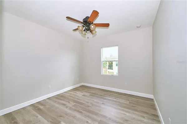 a view of a room with wooden floor