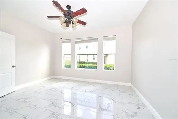 a view of a room with a hanging light and carpet