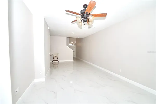 a view of a room with a window and a ceiling fan
