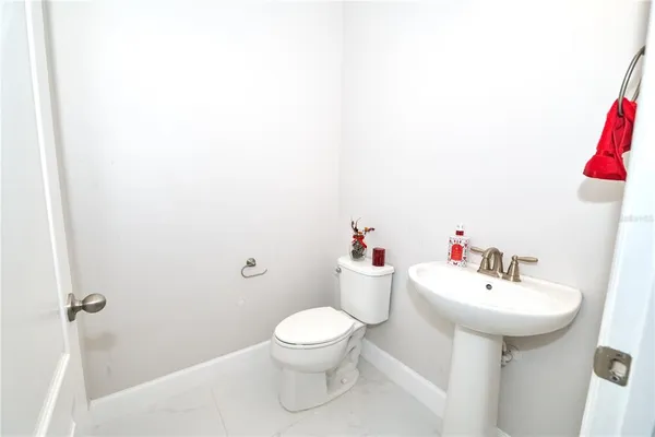 a view of a room with wooden floor and ceiling fan