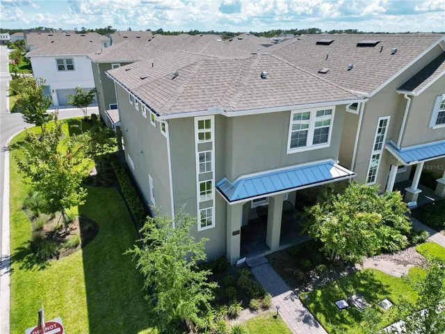 an aerial view of a house with a yard and potted plants