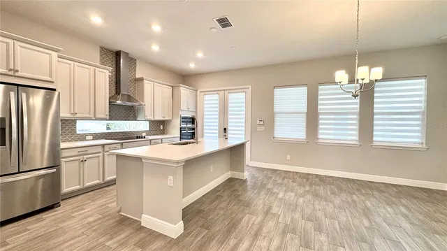 a view of kitchen with kitchen island a sink a stove and a refrigerator