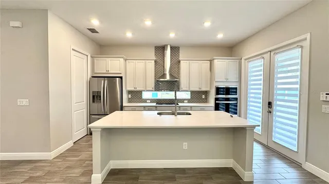 a view of kitchen with refrigerator and window