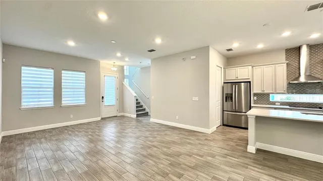 a kitchen with stainless steel appliances granite countertop a refrigerator and a sink