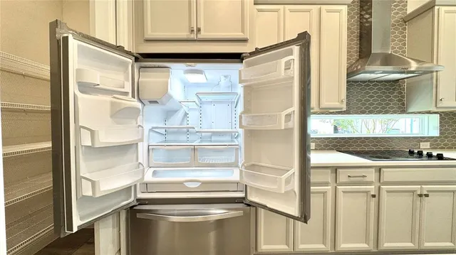 a kitchen with kitchen island a counter top space a sink and refrigerator