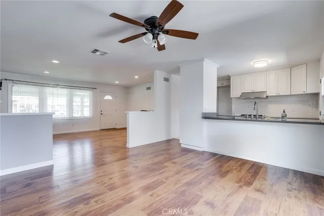 a view of a kitchen with a sink and a window