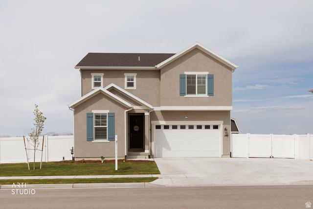 540 Lefty Lane Tooele, UT 84074 - Photo 2 of 48 Traditional-style house featuring stucco siding, a garage, and concrete driveway