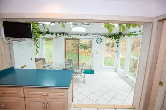 a living room with large windows and a flat screen tv