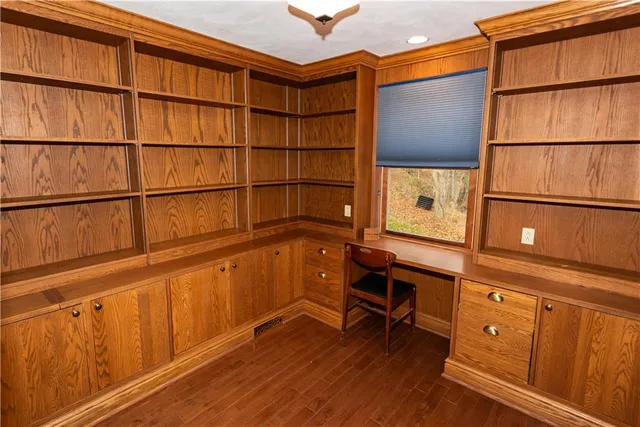 a view of a room with wooden floor and furniture