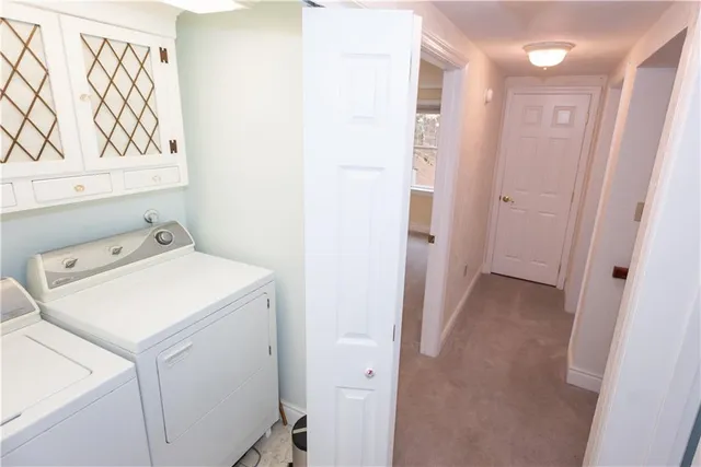 a view of a storage & utility room with a washer dryer