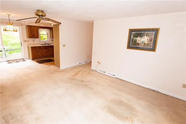 an empty room with a fireplace and a window