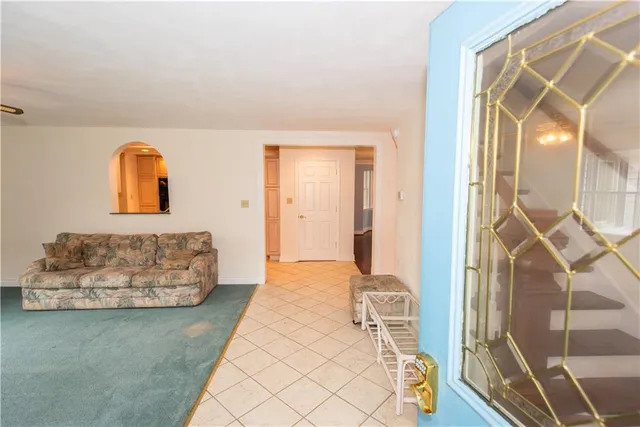 a bedroom with furniture and a mirror