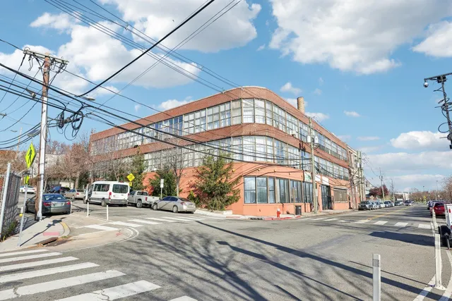 a view of a building with car parked