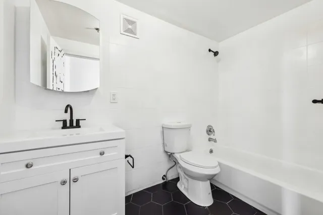 a bathroom with a sink a toilet and a bathtub