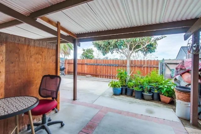 a view of a porch with furniture and a garden