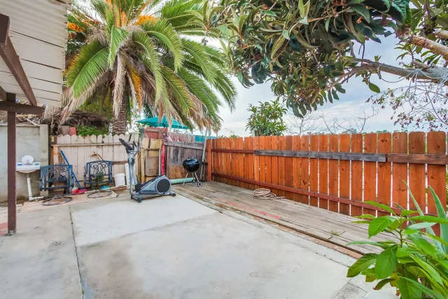 a view of street with wooden fence