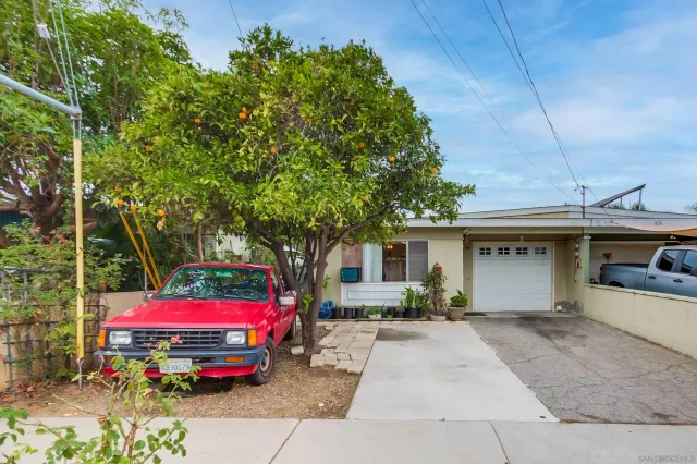a backyard of a house with barbeque oven table and chairs