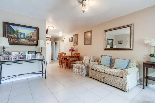 a living room with furniture and painting on the wall