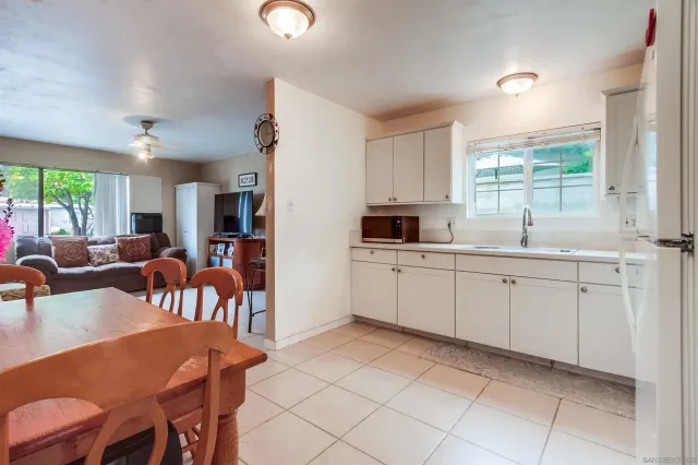 a kitchen with a sink window and cabinets