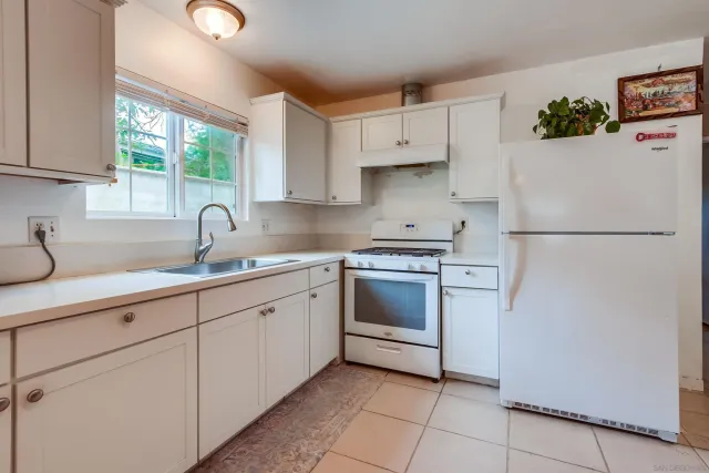 a kitchen with cabinets stainless steel appliances and a sink