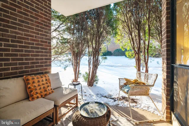 a backyard of a house with fountain table and chairs
