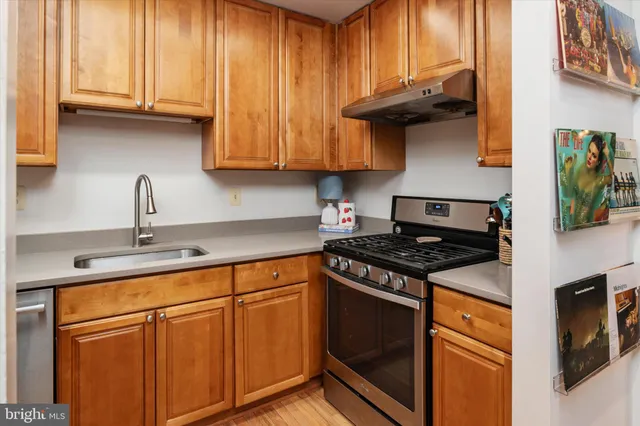 a kitchen with stainless steel appliances granite countertop a stove and a sink