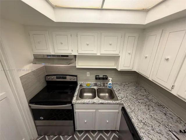 a kitchen with a stove and a sink