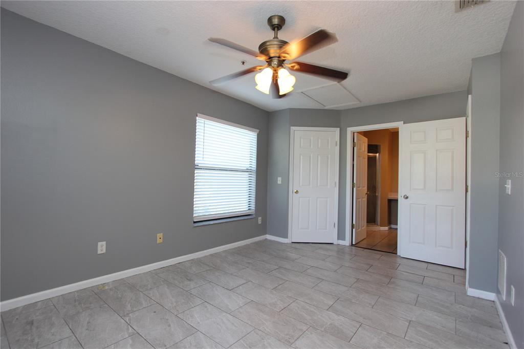 1131 South Pine Ridge Circle, Unit 1 Sanford, FL 32773 - Photo 15 of 19 an empty room with window and ceiling fan