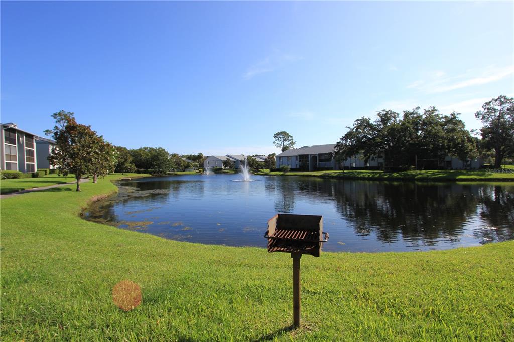 1131 South Pine Ridge Circle, Unit 1 Sanford, FL 32773 - Photo 2 of 19 a lake with lots of green space and fog