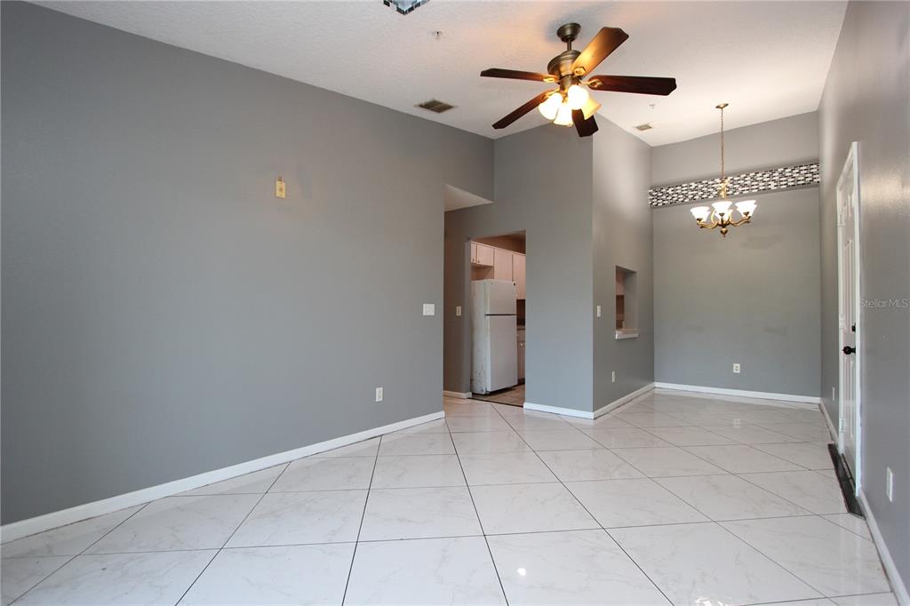 1131 South Pine Ridge Circle, Unit 1 Sanford, FL 32773 - Photo 6 of 19 a view of an empty room with a ceiling fan