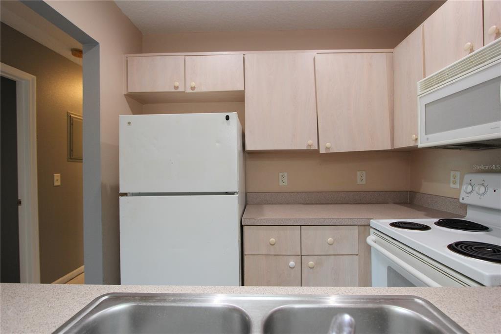1131 South Pine Ridge Circle, Unit 1 Sanford, FL 32773 - Photo 10 of 19 a white refrigerator freezer sitting in a kitchen