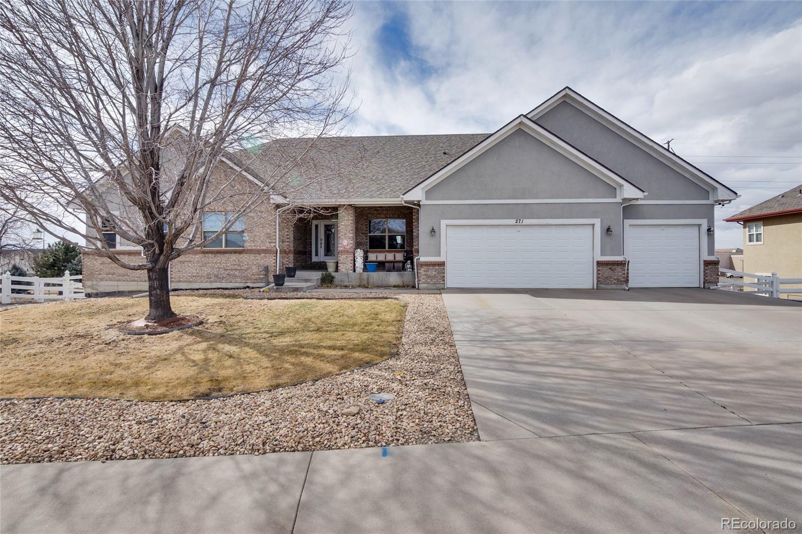 271 Corvette Circle Fort Lupton, CO 80621 - Photo 1 of 39 a front view of a house with a yard covered with snow