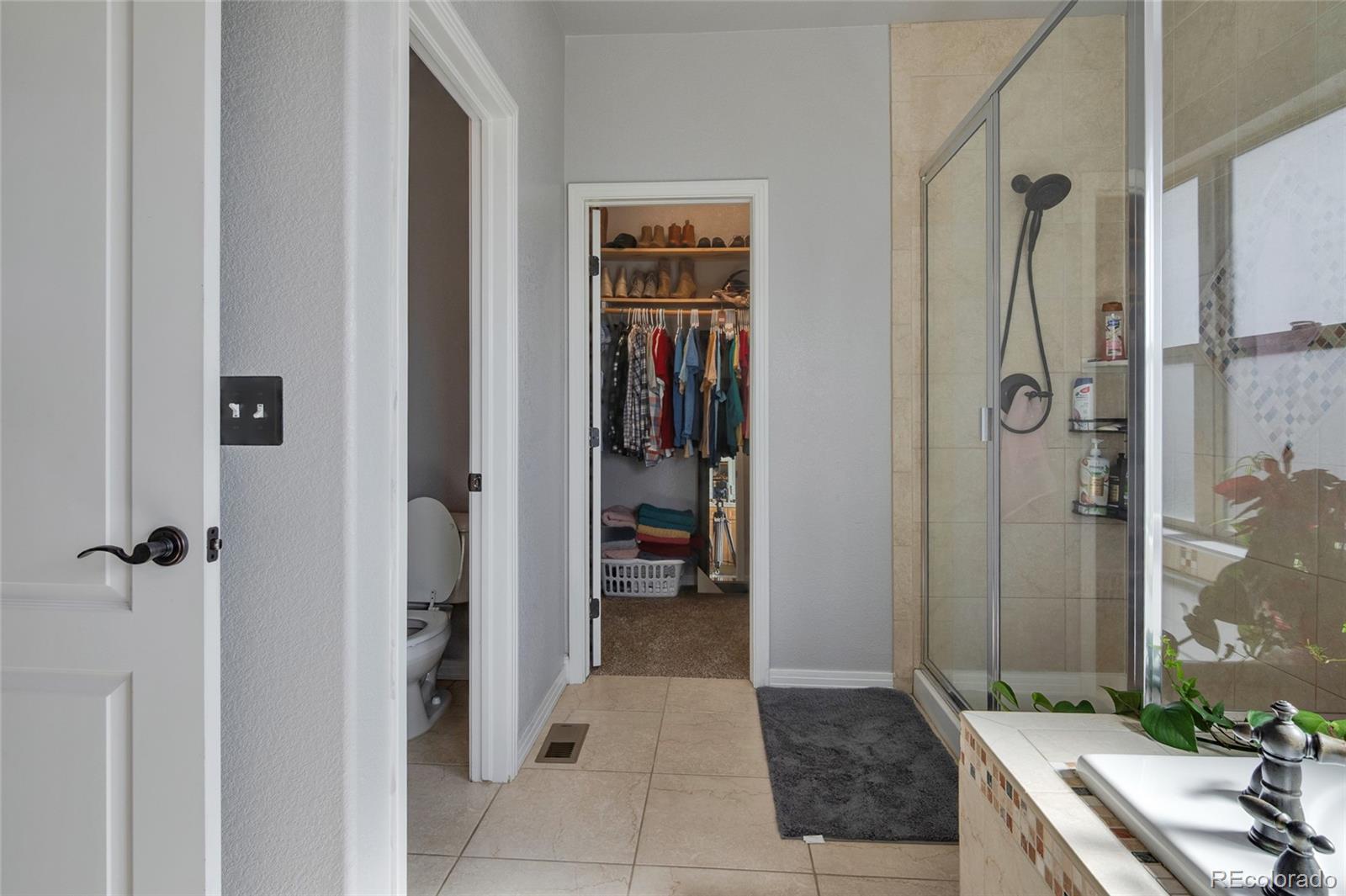 271 Corvette Circle Fort Lupton, CO 80621 - Photo 12 of 39 a bathroom with a granite countertop shower and a sink