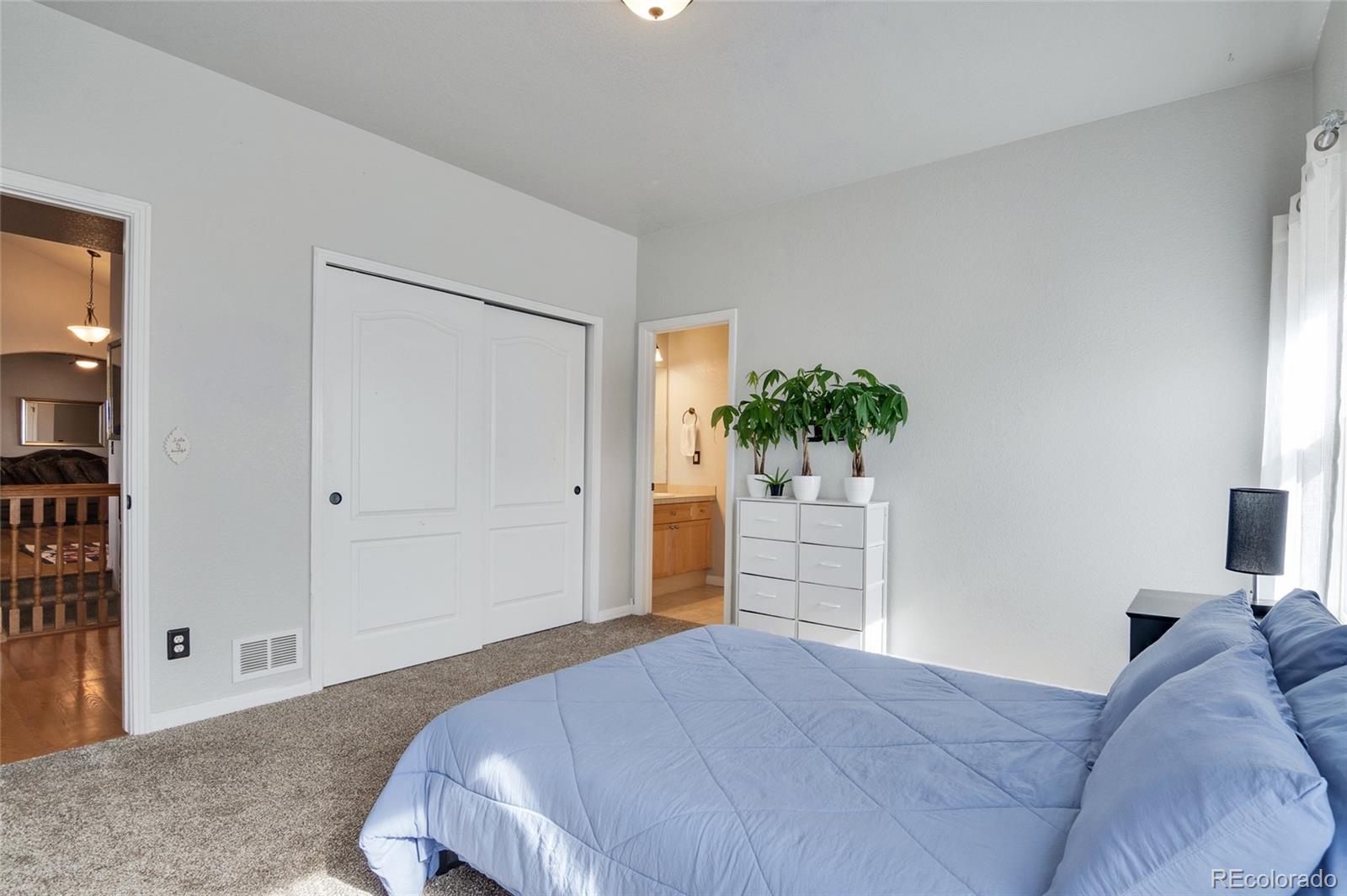 271 Corvette Circle Fort Lupton, CO 80621 - Photo 14 of 39 a bedroom with a bed and cabinets