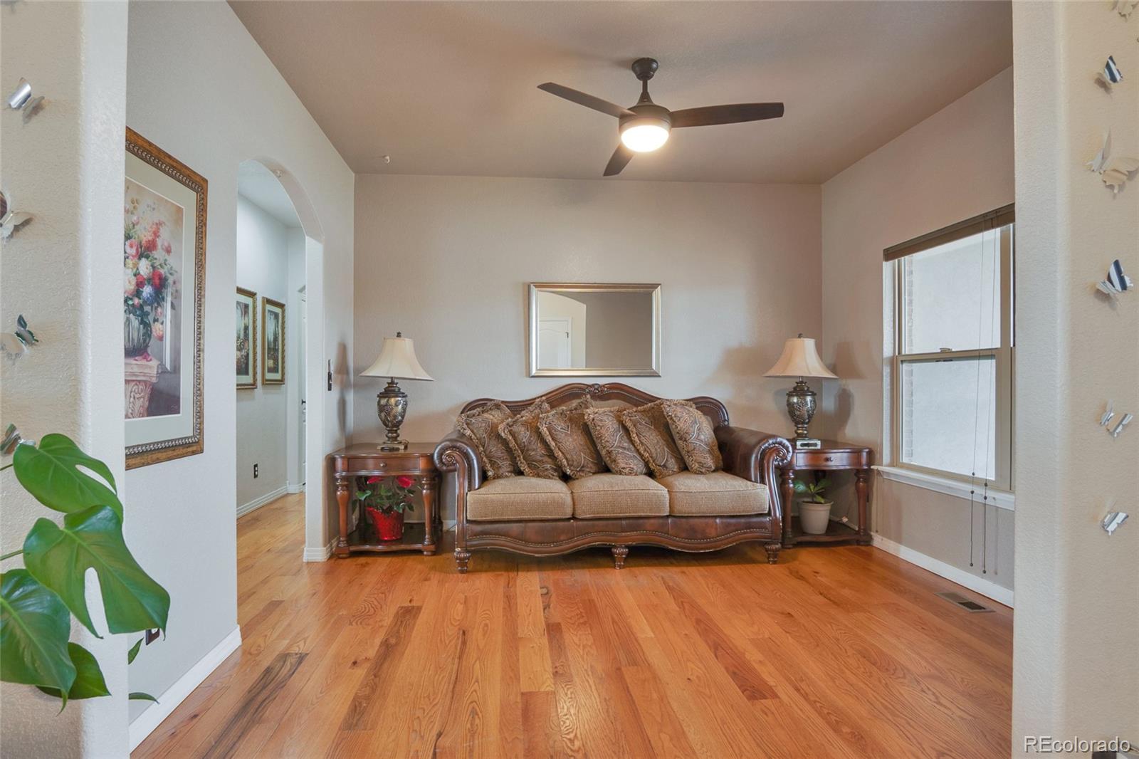 271 Corvette Circle Fort Lupton, CO 80621 - Photo 16 of 39 a living room with furniture and a chandelier