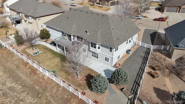 an aerial view of a house with a yard