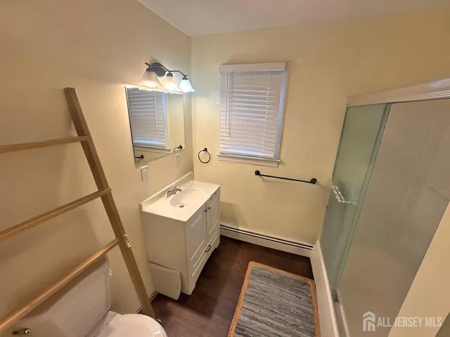 a bathroom with sink toilet and a shower