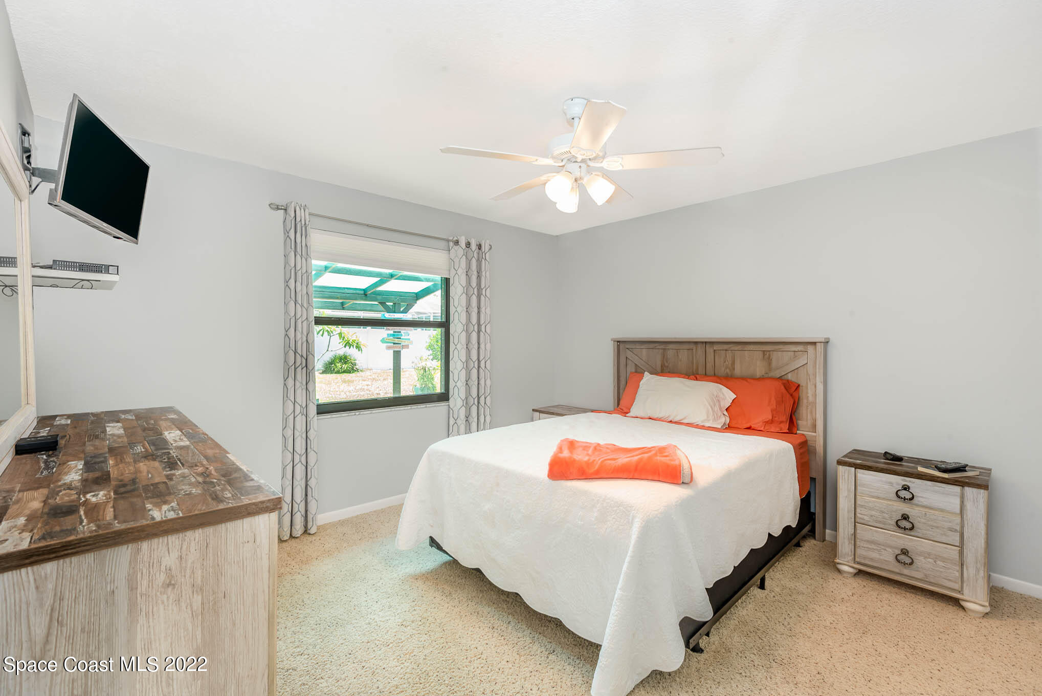 115 Normandy Place Melbourne Beach, FL 32951 - Photo 12 of 31 a bedroom with a bed and a flat screen tv