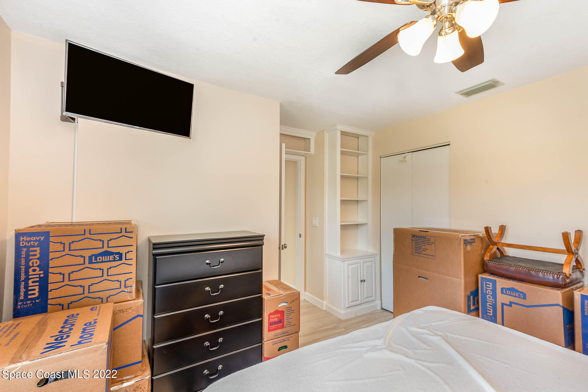 115 Normandy Place Melbourne Beach, FL 32951 - Photo 14 of 31 a bedroom with a bed and a flat screen tv