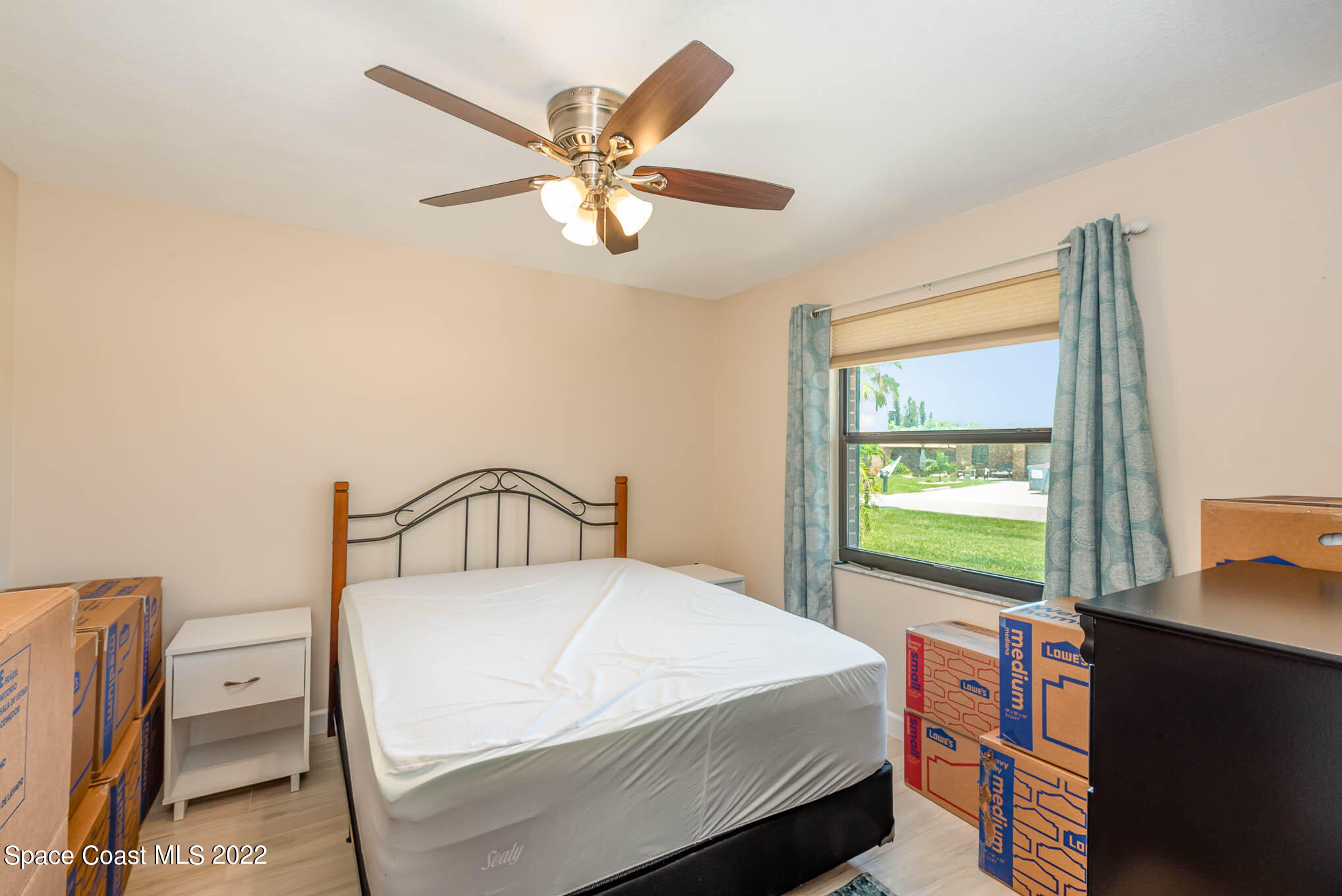115 Normandy Place Melbourne Beach, FL 32951 - Photo 15 of 31 a bedroom with a bed and a chandelier