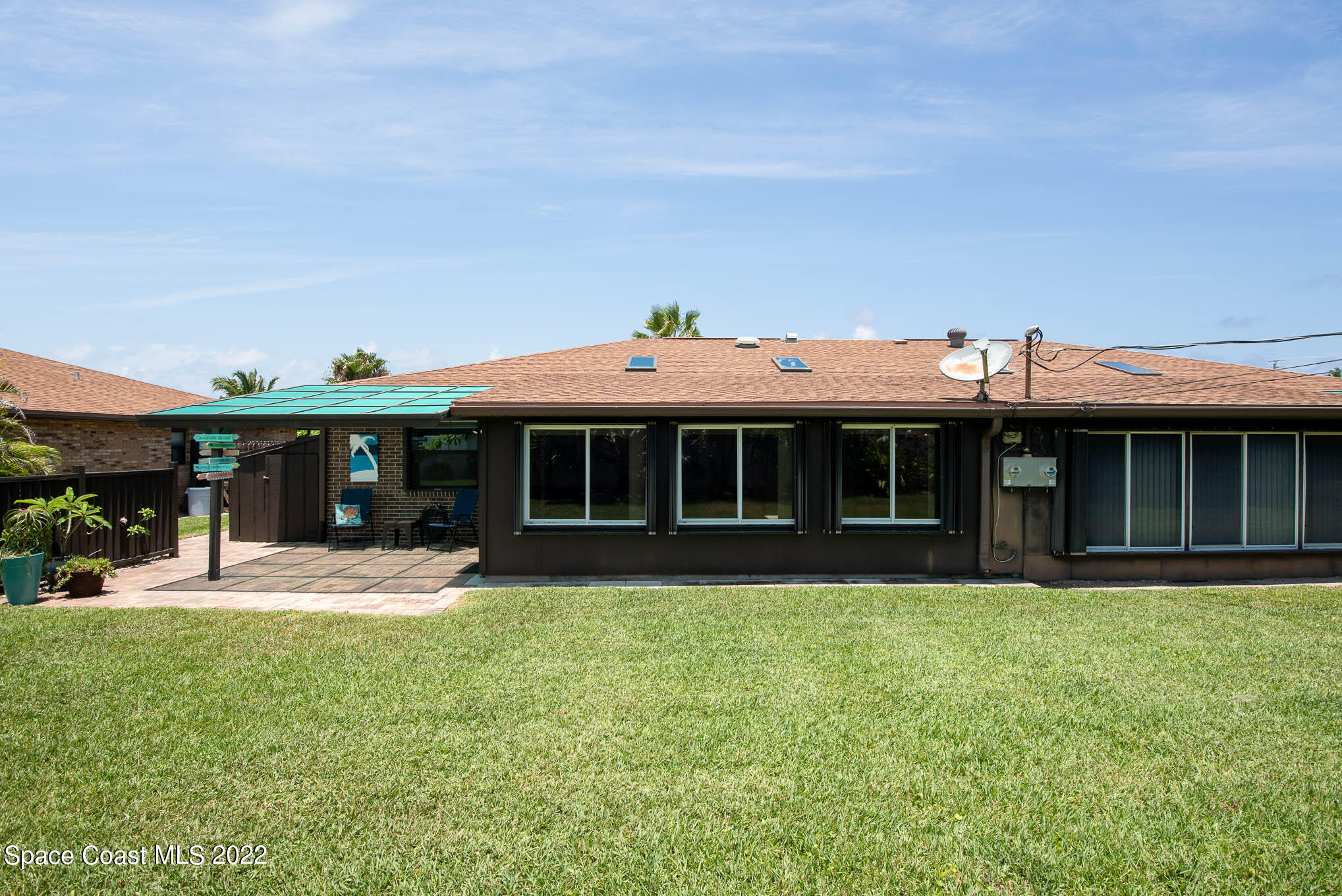 115 Normandy Place Melbourne Beach, FL 32951 - Photo 18 of 31 a front view of a house with a yard and garage